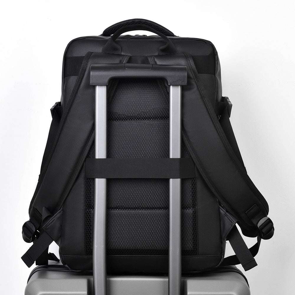 Feldacks large capacity business backpack shown from the back with padded straps on suitcase handle