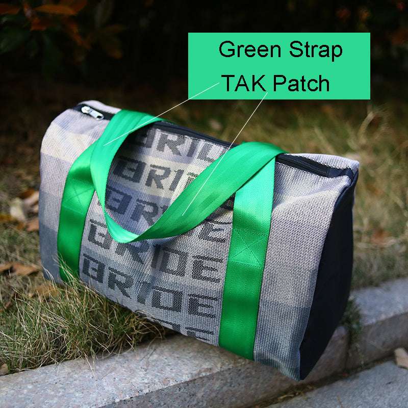 Feldacks canvas carry-on bag for urban travel with green strap and TAK patch resting outdoors
