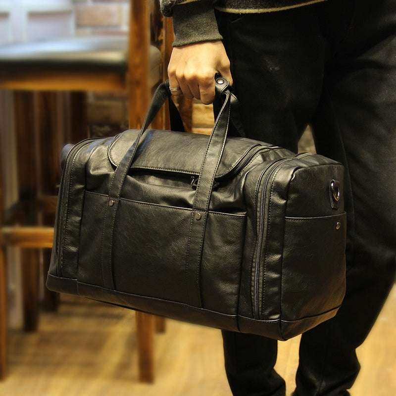 Feldacks urban style PU leather weekend bag in black carried by hand with multiple compartments
