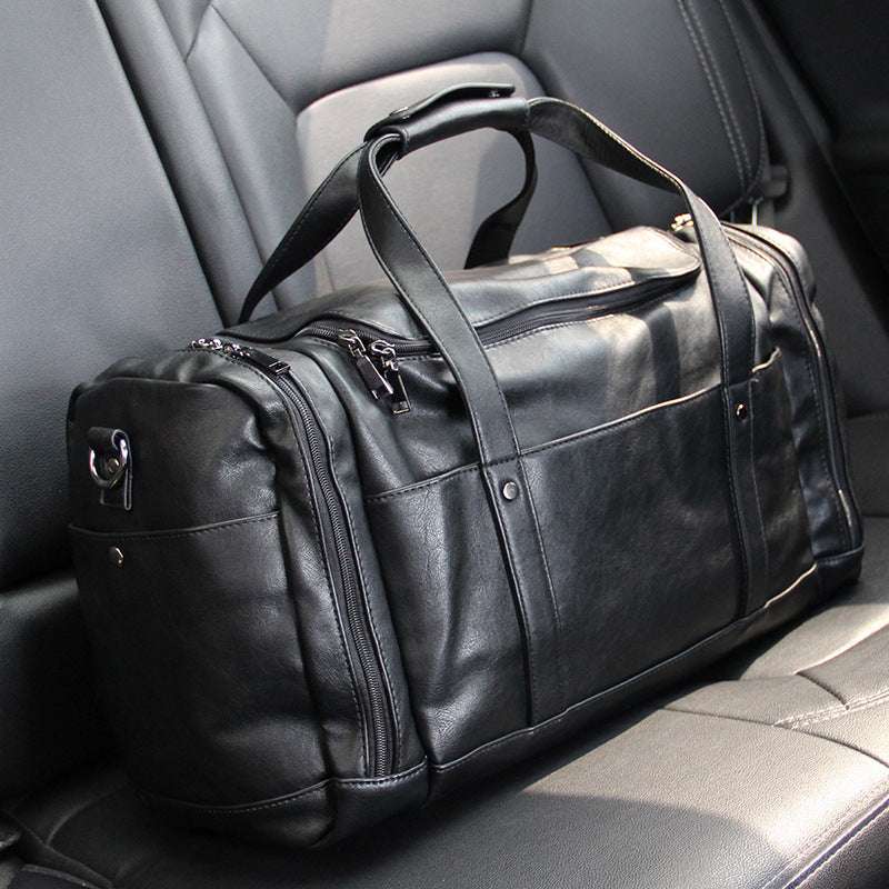 Feldacks black urban style PU leather weekend bag on car seat with multiple compartments