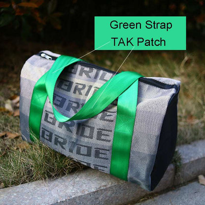 Feldacks canvas carry-on bag for urban travel with green strap and TAK patch resting outdoors