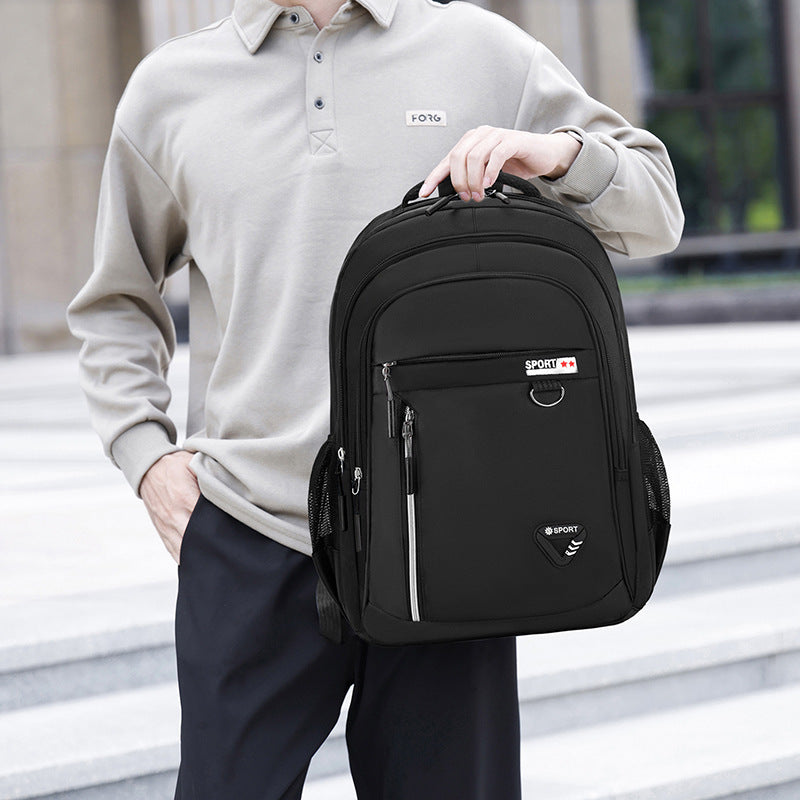 Feldacks men's executive laptop backpack in black held by a man wearing a beige shirt and black pants