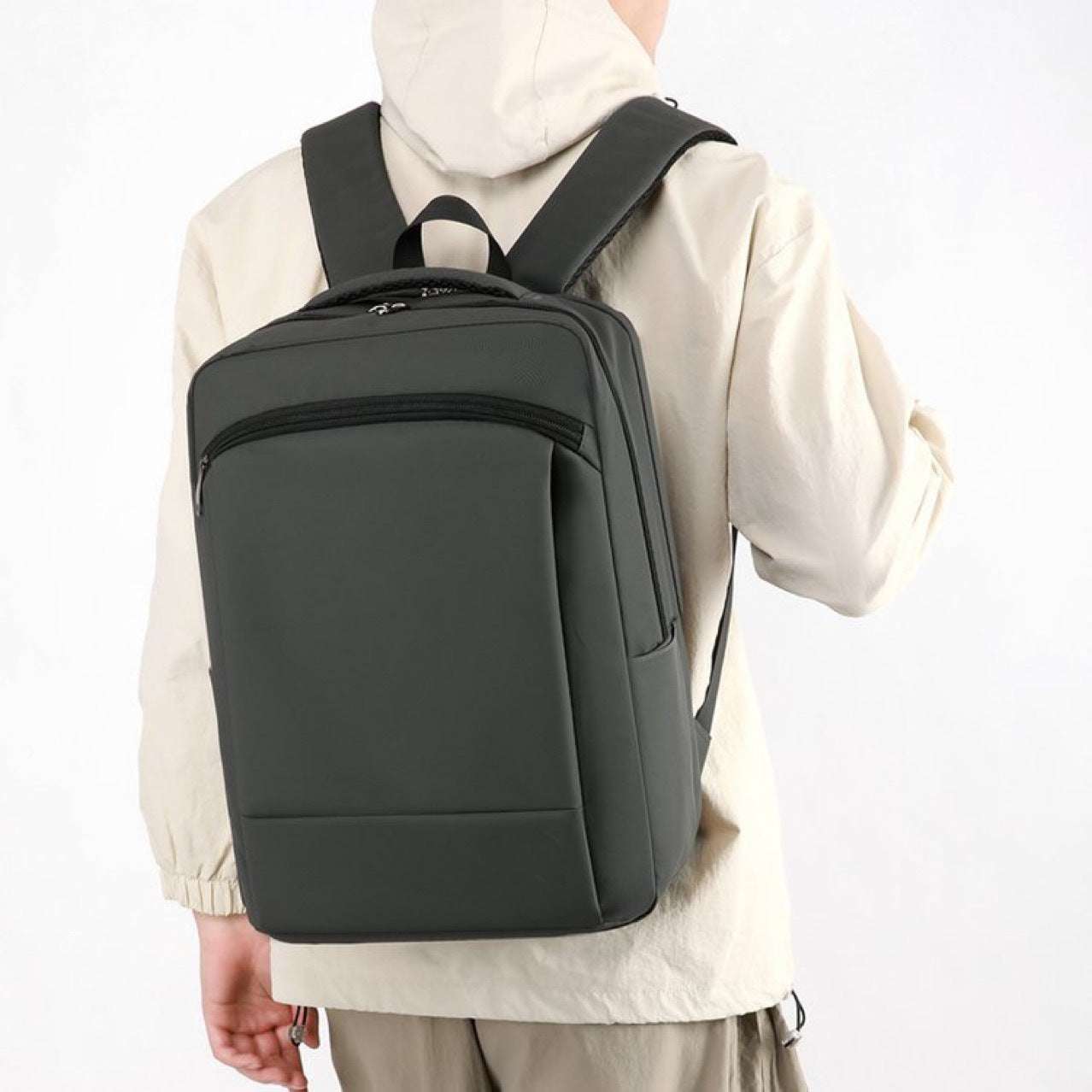 Feldacks professional commuter backpack for work in black worn by person with beige jacket